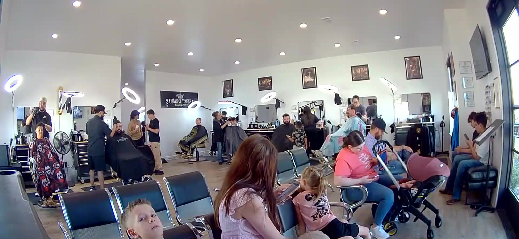 A busy day with families and barbers inside Crown of Thorns